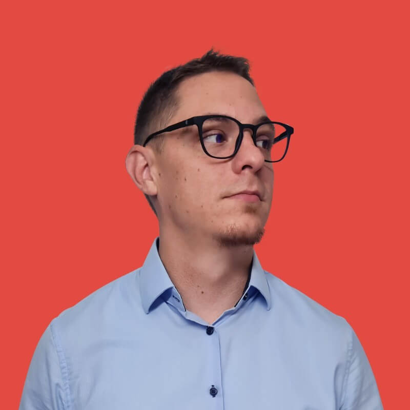 Person wearing glasses against red background
